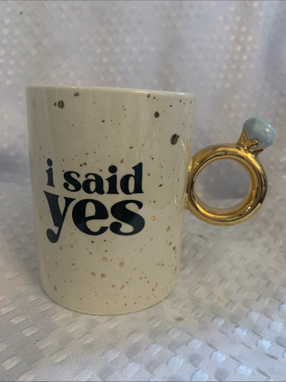 Indigo mug, cream and gold with “ I Said Yes “ in black. Ring shaped handle.